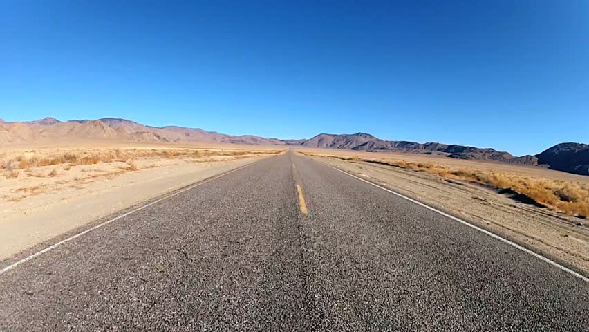 A Sign On A Lonely Desert Road Warns That The Next Services Are 55