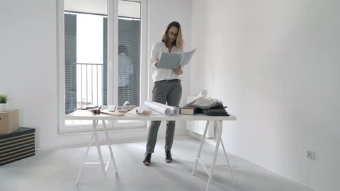 Young Woman With Blueprints Checking Stockvideos Filmmaterial