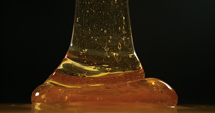 Honey Flowing Against Black Background, Stock Footage Video (100%