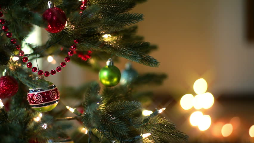 Gold And Red Christmas Ornaments Swinging Against Tree Stock Footage ...