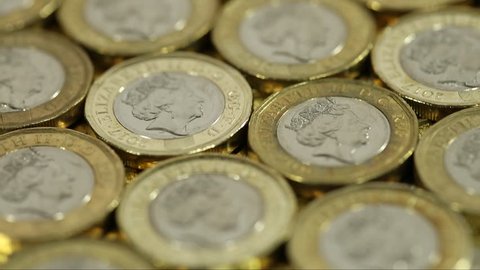 Pound Sterling Currency Exchange Rate Stock Video Footage Slow Tracking Above British Pound Coins