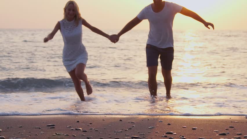 Honeymoon Passionate Couple Holding Hands Walking Down The Beach 