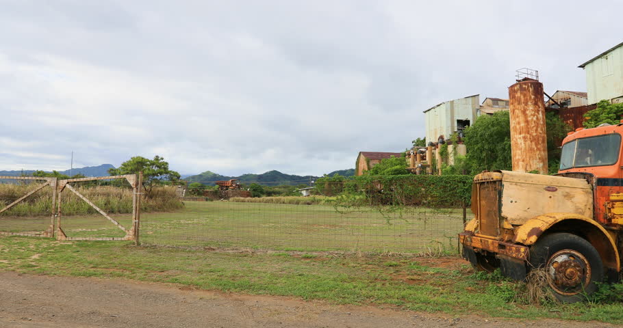 Old Rusting Cars Sit Near An Abandoned Building In The ...