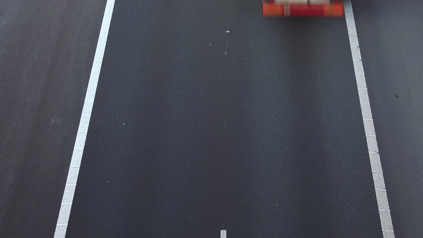 Cars drive on a highway - top view - timelapse - 4K stock video clip