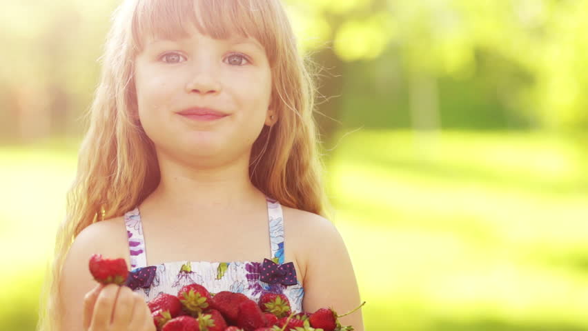 Laughing child eating strawberries 2
