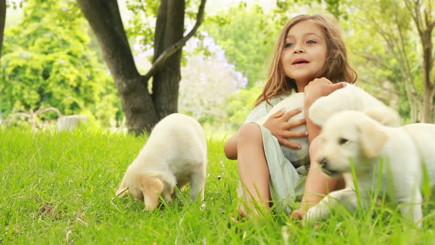 Child Nursing Her Puppy, Little Girl Having Fun Playing With Her Dog ...