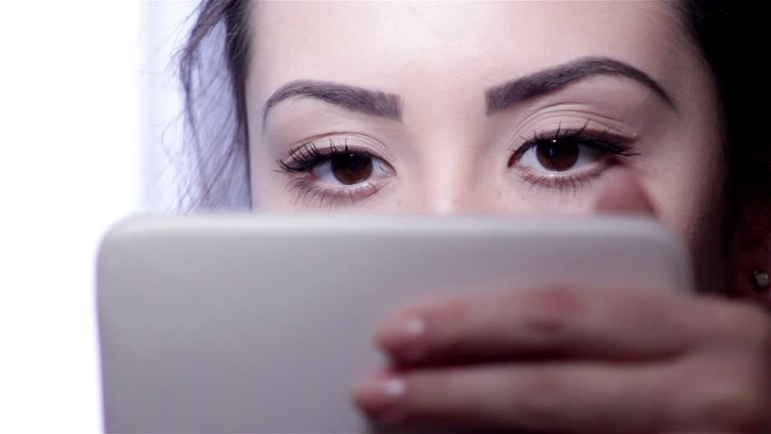 Young woman doing makeup in front of a mirror, full face, blurred background. Beautiful Young Girl Solo - Young woman doing makeup in front of a mirror, full face, blurred background.