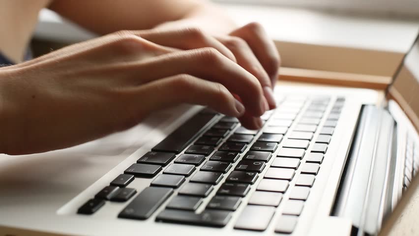 Women's hands typing on computer keyboard (HD)