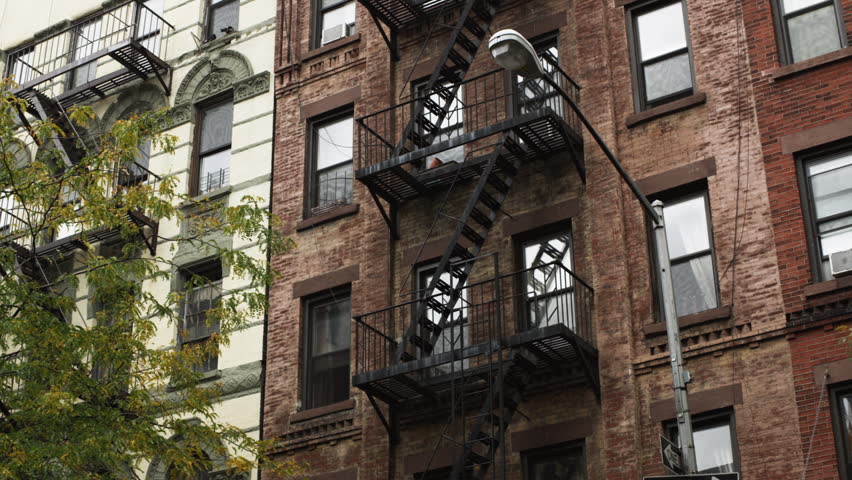 Apartment Building Exterior medium shot pan exterior of apartment building with fire escape Apartment Building Exterior medium shot pan exterior of apartment building with fire escape