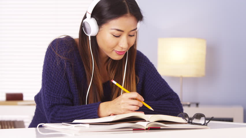 Chinese Woman Listening To Music While Doing Homework Stock Footage Video 6819847 Shutterstock