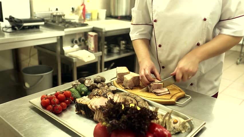 Restaurant Kitchen Video chef is cutting filet mignon to pieces, at a restaurant kitchen Restaurant Kitchen Video chef is cutting filet mignon to pieces, at a restaurant kitchen