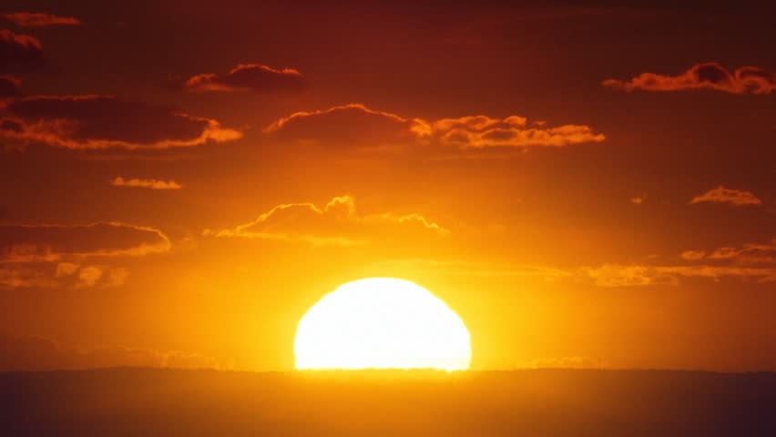 A Time Lapse Of The Large Orange Sunset As The Massive Sun Sets Into ...