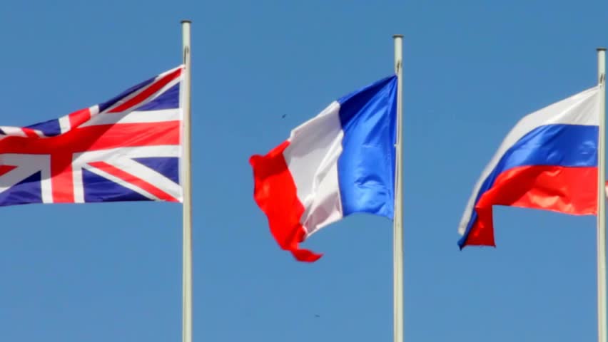 Flags Of Great Britain France And Russia On Blue Sky Background