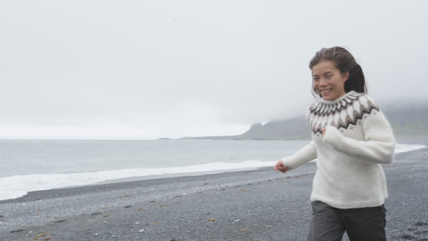 Beautiful Woman Walking On Black Sand Beach On Iceland Wearing ...