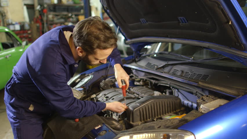 Mechanic Repairs Car Engine in Stock Footage Video (100% Royalty-free