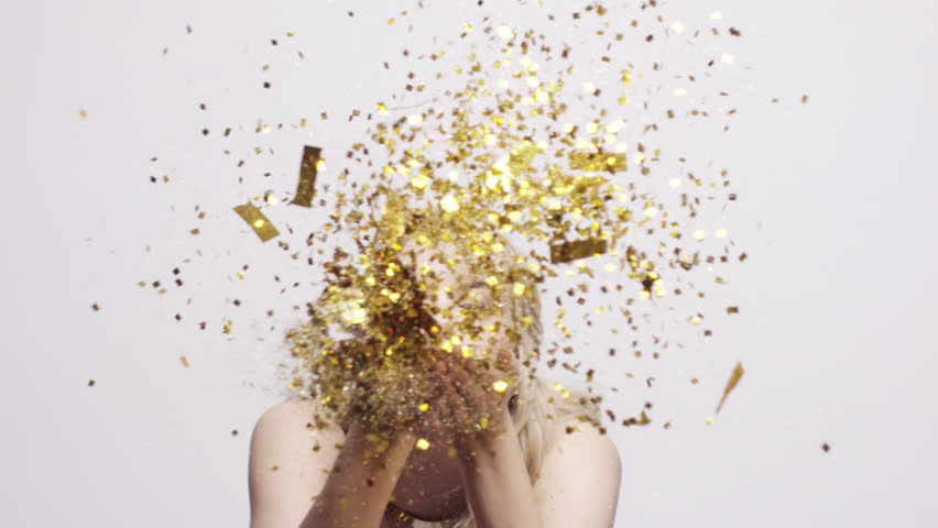 beautiful hispanic woman blowing gold glitter confetti beautiful hispanic woman blowing gold glitter confetti