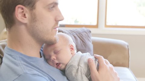 baby sleeping on dads chest