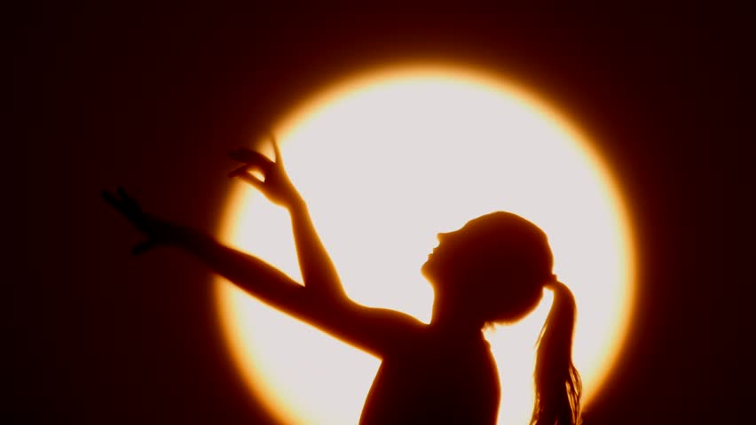 Silhouette Of Woman Head With Sunshine Behind, Holding Two Fists ...